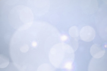 abstract blur white bokeh circles on blue background.