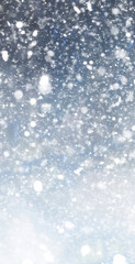 Abstract winter christmas background with shiny snow and blizzard. Space for text. Vertical for stories
