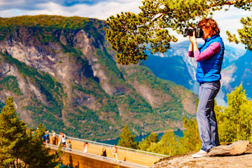 Fototapeta na wymiar Tourist on nature take travel picture, Norway