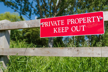 Shallow focus of a newly installed Private Property sign seen on a time fence near the entrance to a private paddock. The area has been subject to thefts.