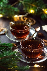 Couple cups of hot spicy tea with anise and cinnamon, selective focus