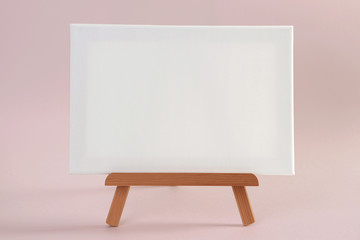 White canvas on small wooden easel, mock-up