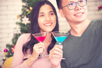 Young Asian couples are celebrating Christmas festivities in a warm, fun-filled, holiday-filled, high-end Christmas and New Year holiday concept.