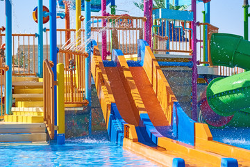 Colorful slides in the waterpark close up. Aquapark sliders with pool