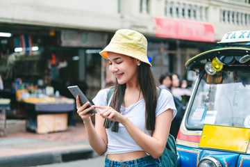 Traveler woman using mobile phone in bangkok city