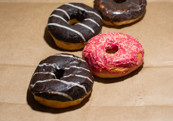 Tasty delicious doughnuts on eco paper background