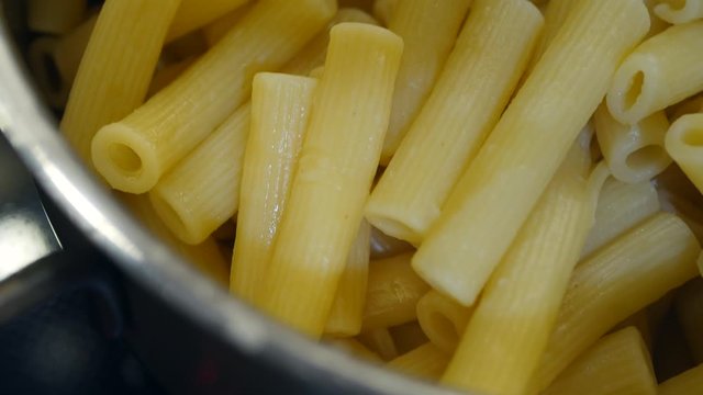 Cooked Pasta In A Saucepan On The Stove Panning Handheld Shot.