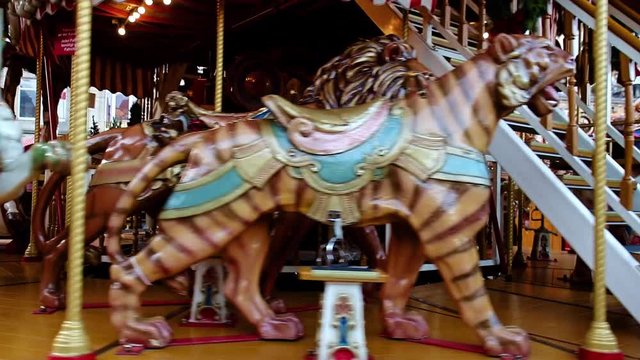 The vintage decoration carousel rotating without  people at market.The amusement park. Old retro merry-go-round is turn.