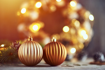 Christmas decorations with golden balls, fir tree branch and garland lights on a dark background © Lazy_Bear
