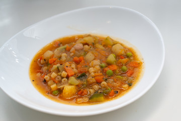 minestrone, soup of fresh vegetables in the foreground