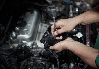 Fototapeta na wymiar Hands of mechanic working in auto repair shop. Auto repair service.