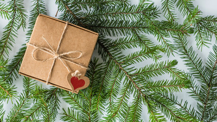 packing gift in a box of kraft paper on white wood table. Christmas tree, spruce branches. concept. New Year. concept. Flat lay, top view