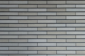 テクスチャ―　櫛引タイルの壁面　texture of beige color brick wall