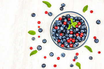 Fresh blueberries and red currants with mint leaves. Diet food, vegan berries