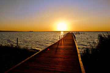 Fototapeta na wymiar Jetty on a lake during sunset