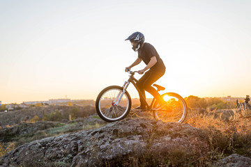 Cyclist riding the mountain bike at beautiful sunset.
