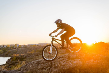 Fototapeta na wymiar Extreme mountain biking at beautiful sunset, downhill.