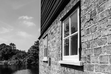 Architectural view of exterior windows seen on an old water mill.