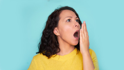 Health Care: Woman checking her breath with hand. Closeup portrait headshot sleepy young woman with...