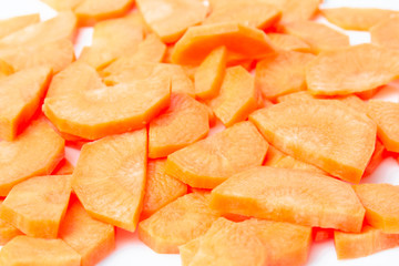 Slices of fresh ripe carrots on a white background isolate