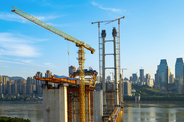 Naklejka premium A bridge under construction on the Yangtze River, Chongqing, China