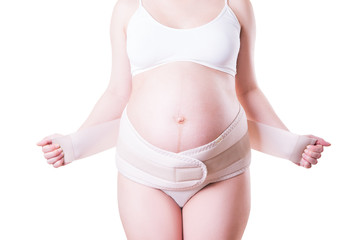 Fototapeta na wymiar Pregnant woman with orthopedic support belt, isolated on white background