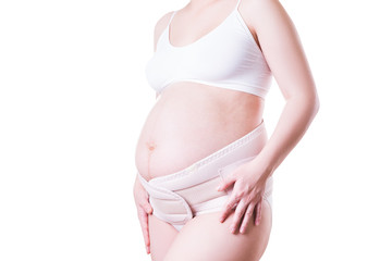 Pregnant woman with orthopedic support belt, isolated on white background