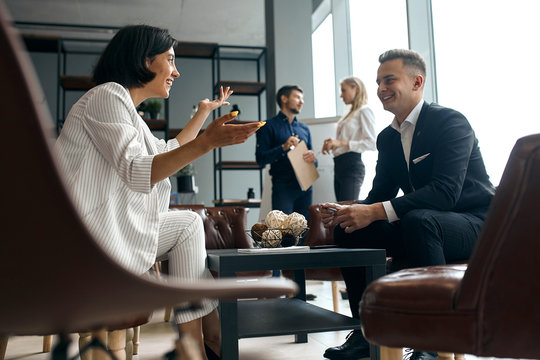 young businessman and businesswoman having fun during the conversation. close up side view photo
