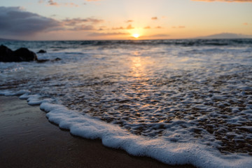 Gentle wave brushes the beautiful coast of Maui, Hawaii