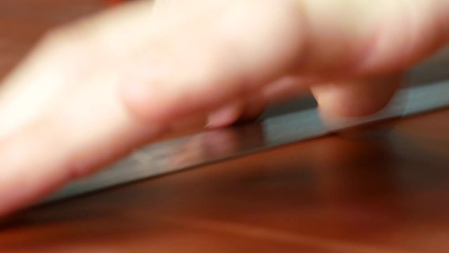 Craftsman makes a line of markings on the leather cloth using a ruler. Close-up 4k