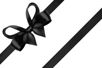 Black ribbon with gift bow isolated on white. Festive bow of black shiny satin ribbon and line of ribbon
