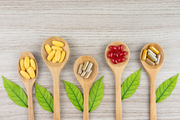 Alternative herbal medicine, vitamin and supplements from natural on rustic wood background, drug concept