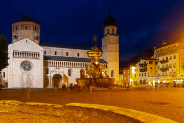 Fototapeta na wymiar Nettuno Fountain in Duomo square and Civic tower. Trento. Italy