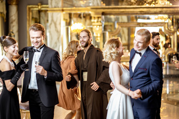 Group of elegant people dancing indoors