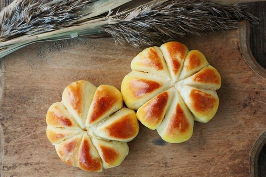 Delicious fresh buns on a wooden table
