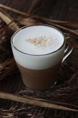 Delicious cappuccino with milk on a wooden table