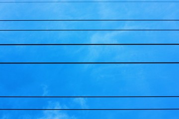 Black metal mesh on the background and blue sky 