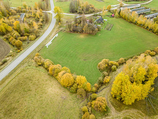 countryside view from above in Latvia with cultivated fields and road network in autumn