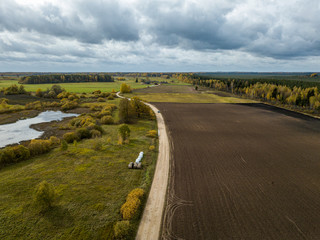 Fototapeta premium countryside view from above in Latvia with cultivated fields and road network in autumn