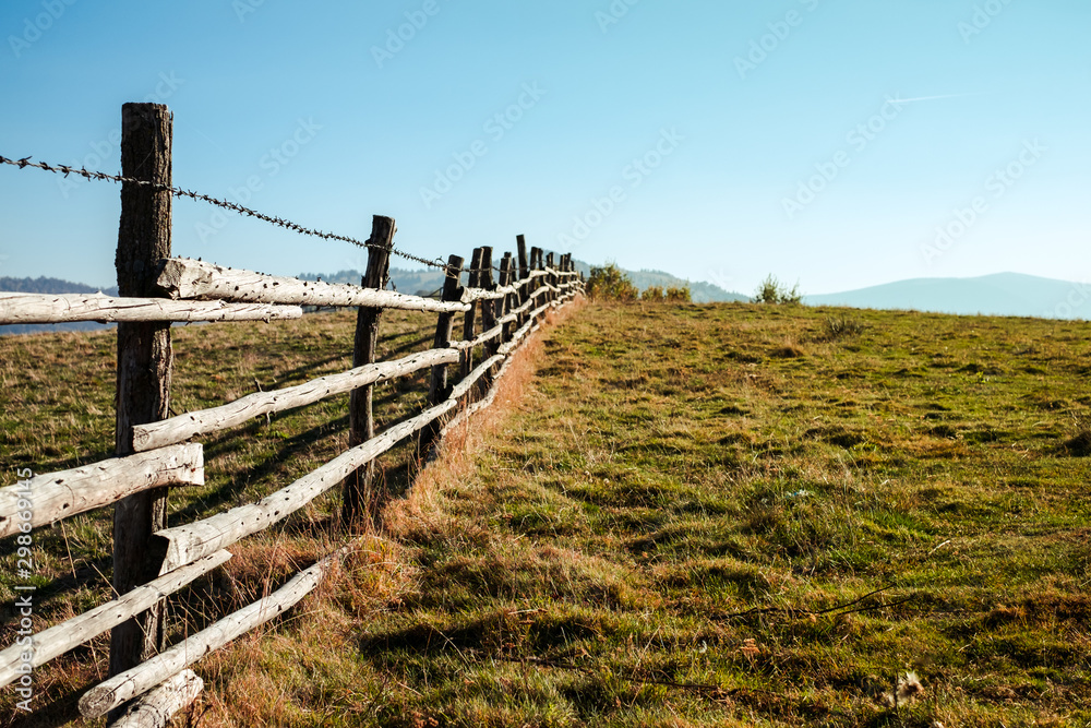 Wall mural old wooden fence with barbed wire