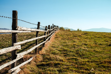 old wooden fence with barbed wire