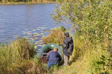 Children prepare an inflatable boat for launching