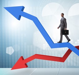 The businessman with charts of growth and decline