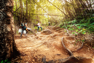 local adventure travel activity from beautiful tropical forest with sunlight and asian couple walk and hike to top fo mountain for see nature view