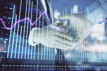 Double exposure of financial chart on cityscape background with two businessmen handshake. Concept of financial analysis and investment opportunities