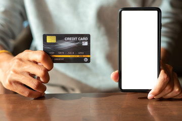 Credit cards and mobile phones are placed on the table for graphic design work.