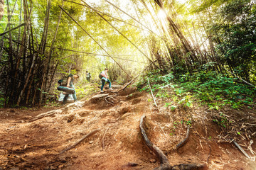 local adventure travel activity from beautiful tropical forest with sunlight and asian couple walk and hike to top fo mountain for see nature view