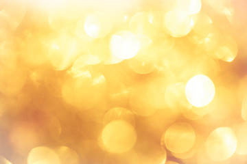 golden color blurred abstract background. yellow bokeh christmas blurred beautiful shiny Christmas lights.