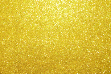 gold Sparkling Lights Festive background with texture. Abstract Christmas twinkled bright bokeh...