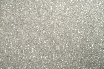 Silver Sparkling Lights Festive background with texture. Abstract Christmas twinkled bright bokeh defocused and Falling stars. Winter Card or invitation	